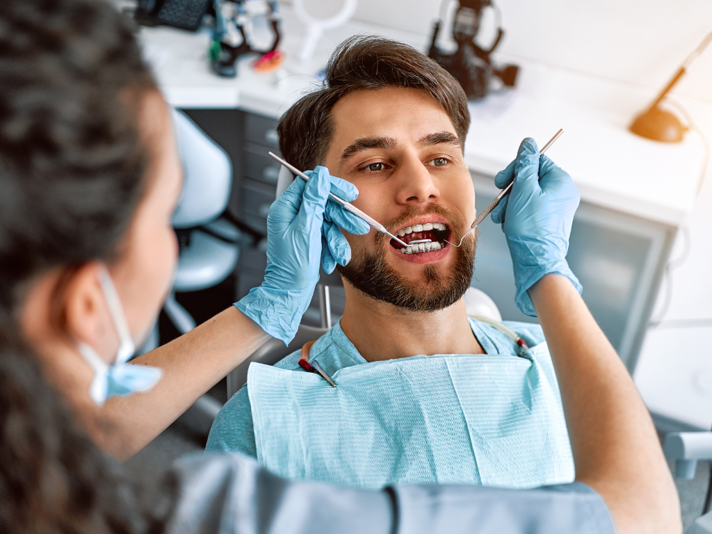 Dentist examining a patient at Synergy, a dental clinic in Islamabad